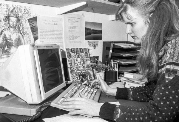 Dharmacharini working on a computer